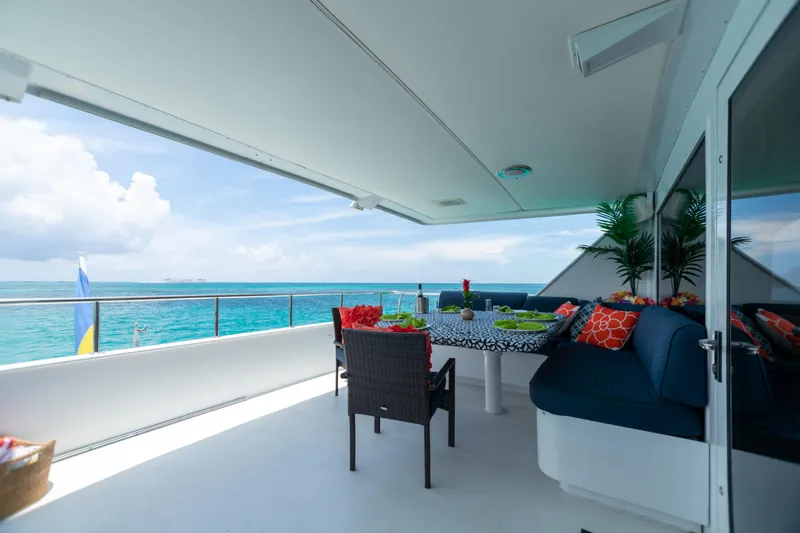 Slide: The Image of Luxurious deck of 1991 Broward Motor Yacht with ocean view and outdoor seating. - 21
