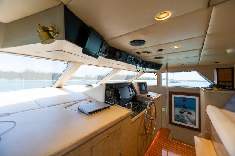 Slide: The Image of Interior helm of 1991 Broward Motor Yacht with navigation equipment and panoramic windows. - 24