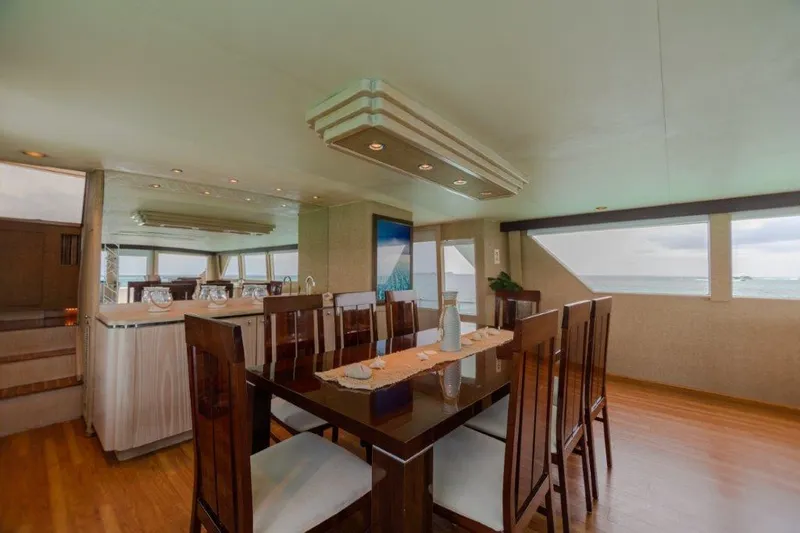 Slide: The Image of Luxurious dining area on a 1991 Broward Motor Yacht with ocean views. - 28