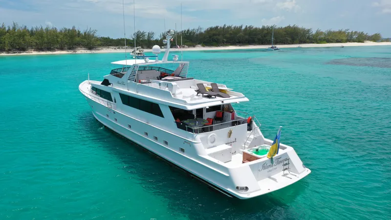 Slide: The Image of Broward 1991 Motor Yacht cruising in turquoise waters near a tropical island. - 3