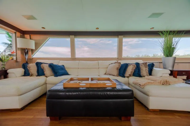 Slide: The Image of Luxurious interior of a 1991 Broward Motor Yacht with plush seating and panoramic windows. - 30