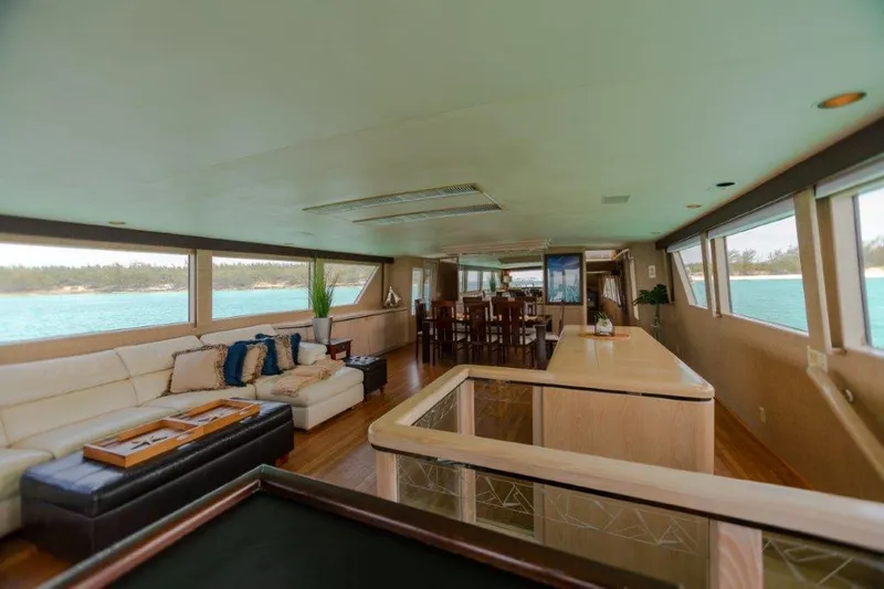 Slide: The Image of Luxurious interior of a 1991 Broward Motor Yacht with panoramic windows and elegant furnishings. - 31