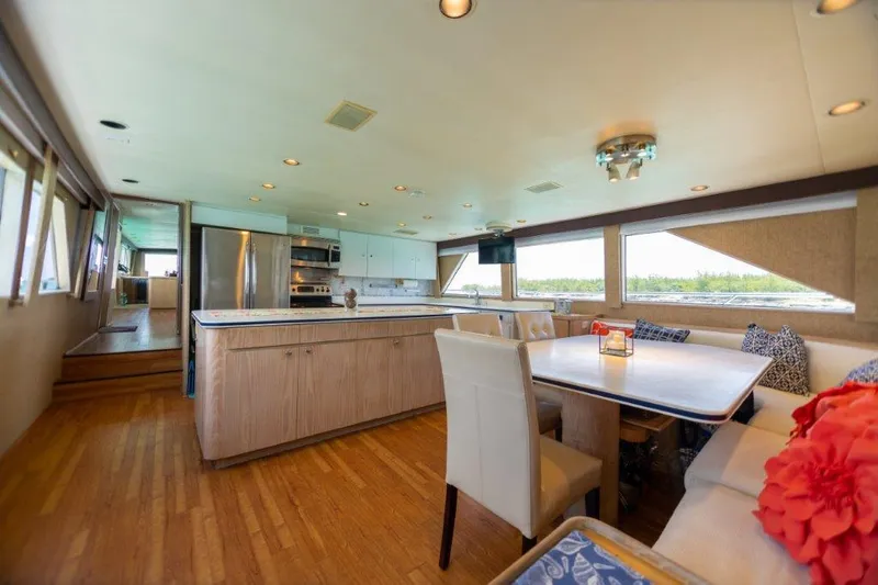 Slide: The Image of Spacious interior of 1991 Broward Motor Yacht with modern kitchen and dining area. - 33