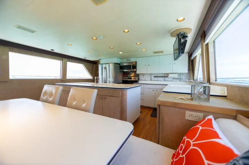 Slide: The Image of Interior of 1991 Broward Motor Yacht with modern kitchen and dining area. - 35