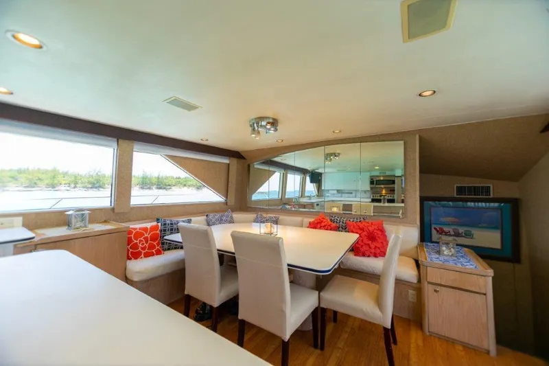 Slide: The Image of Luxurious dining area inside a 1991 Broward Motor Yacht with scenic window views. - 37