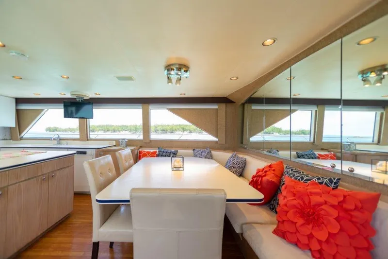Slide: The Image of Luxurious dining area on a 1991 Broward Motor Yacht with scenic window views. - 38