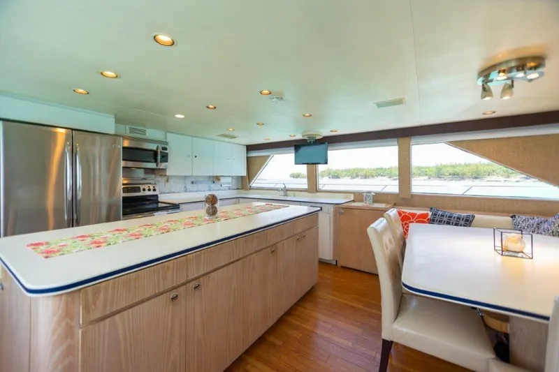 Slide: The Image of Spacious kitchen and dining area inside a 1991 Broward Motor Yacht. - 39