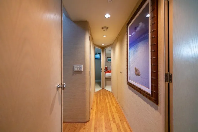 Slide: The Image of Hallway interior of a 1991 Broward Motor Yacht with wooden flooring and wall art. - 41
