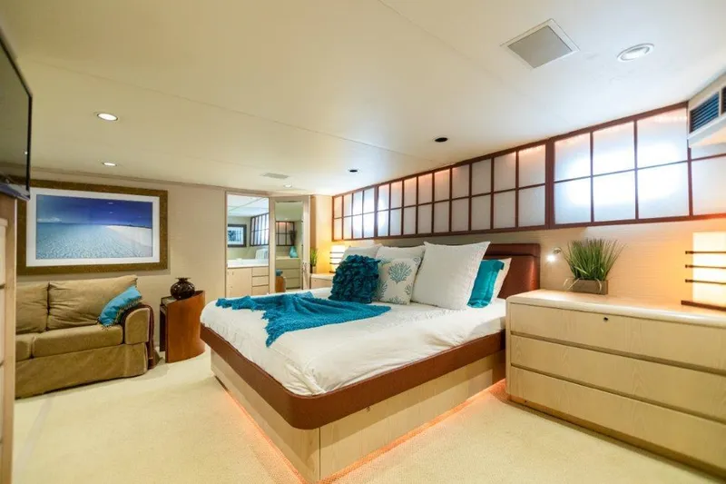 Slide: The Image of Luxurious bedroom interior of 1991 Broward Motor Yacht with modern decor and ambient lighting. - 42