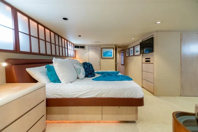 Slide: The Image of Luxurious bedroom interior of 1991 Broward Motor Yacht with modern decor and ample storage. - 48