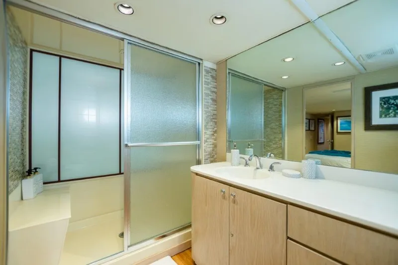 Slide: The Image of Modern bathroom in 1991 Broward Motor Yacht with frosted glass shower and large mirror. - 49