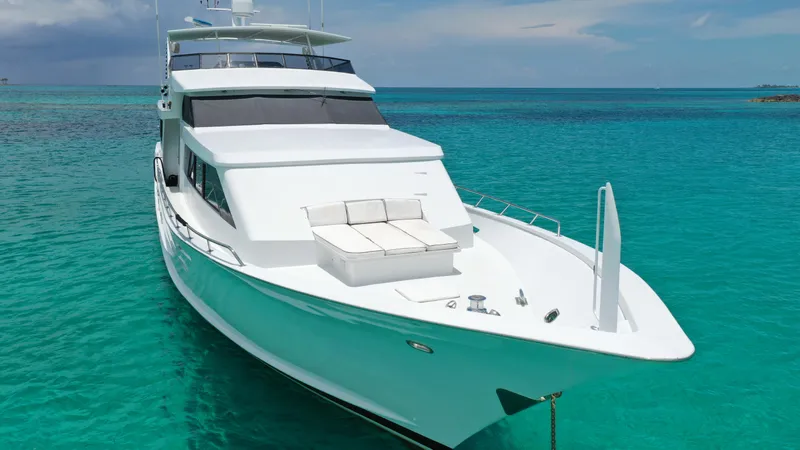 Slide: The Image of 1991 Broward Motor Yacht anchored in clear turquoise waters. - 6