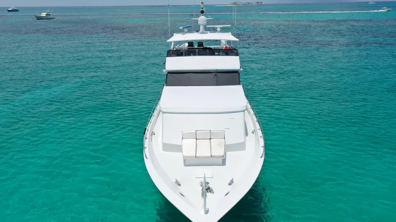 Slide: The Image of 1991 Broward Motor Yacht cruising on clear turquoise waters. - 7