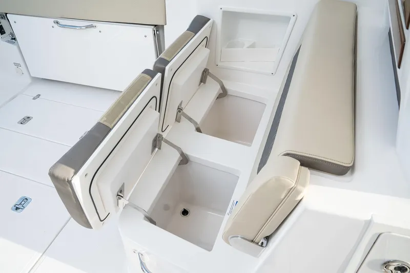 Slide: The Image of 2025 Pursuit DC 365 Dual Console boat with open storage compartments and seating. - 11