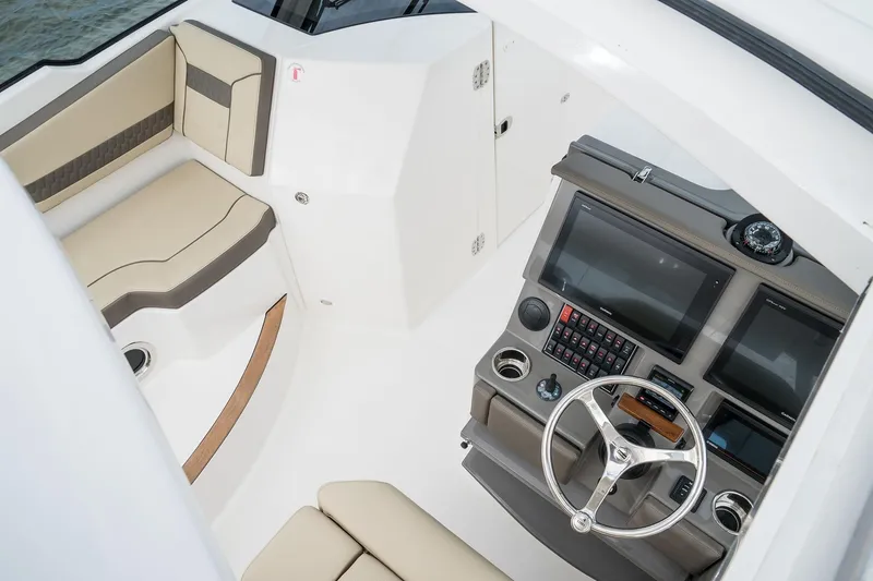 Slide: The Image of 2025 Pursuit DC 365 Dual Console boat interior with helm and seating area. - 12