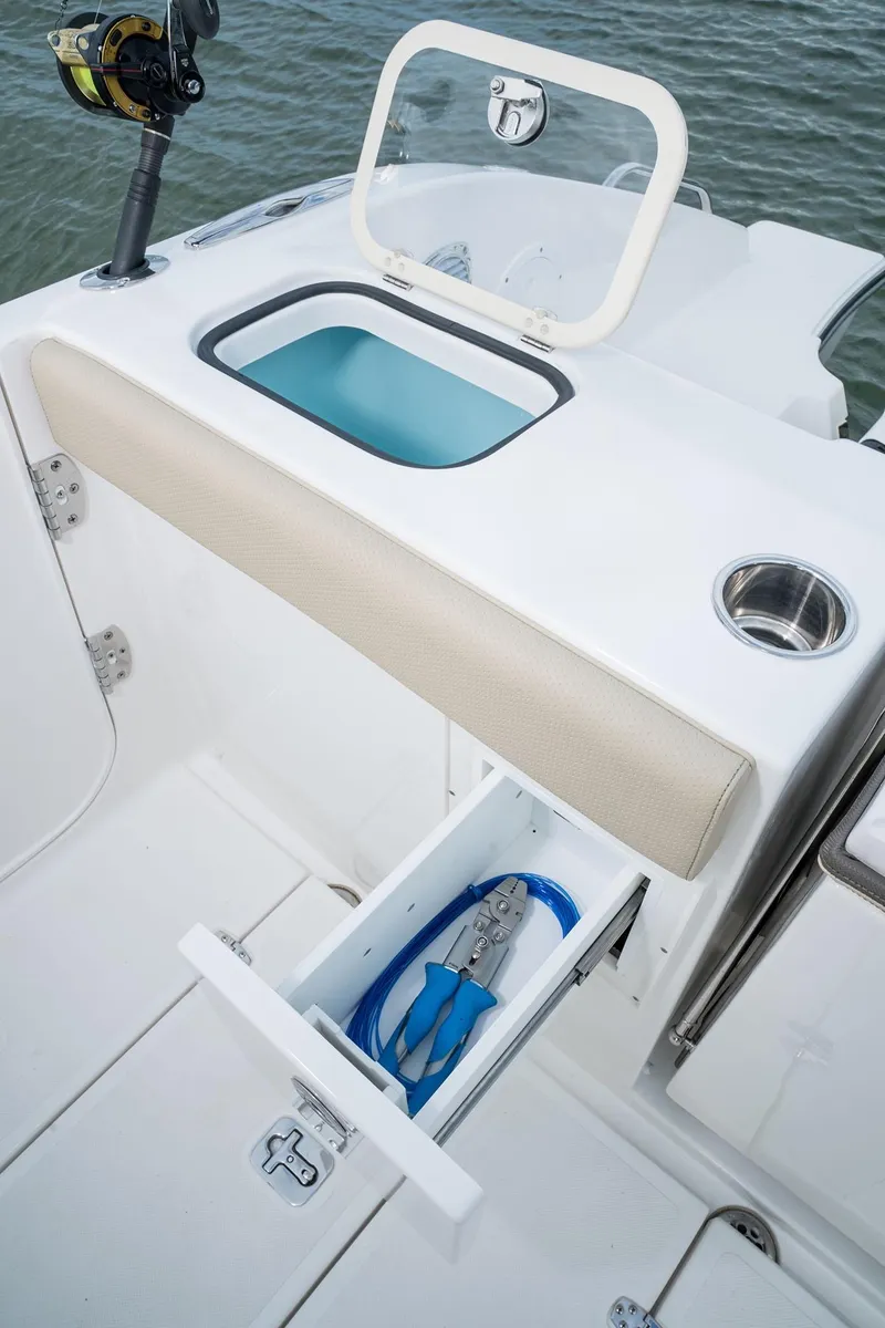 Slide: The Image of 2025 Pursuit DC 365 Dual Console fishing station with storage drawer and rod holder. - 15