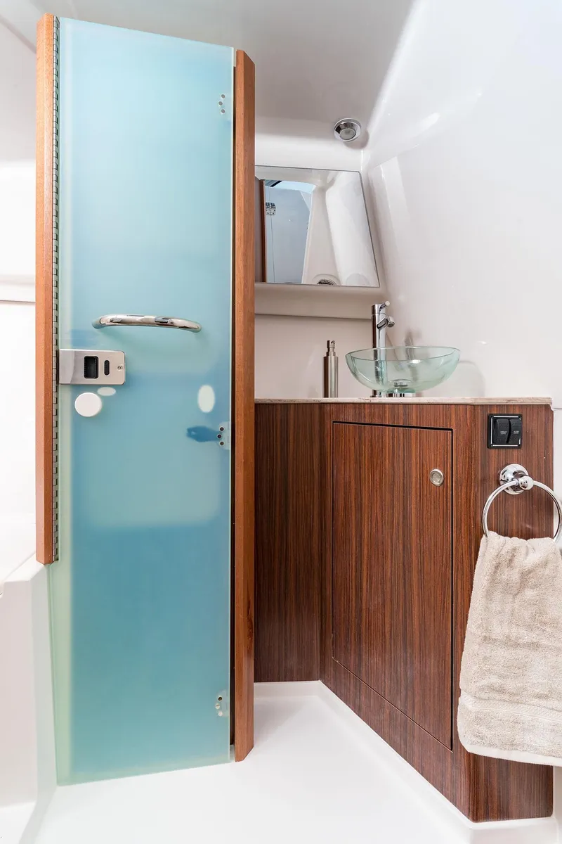Slide: The Image of Modern bathroom in 2025 Pursuit DC 365 Dual Console boat with frosted glass door. - 20