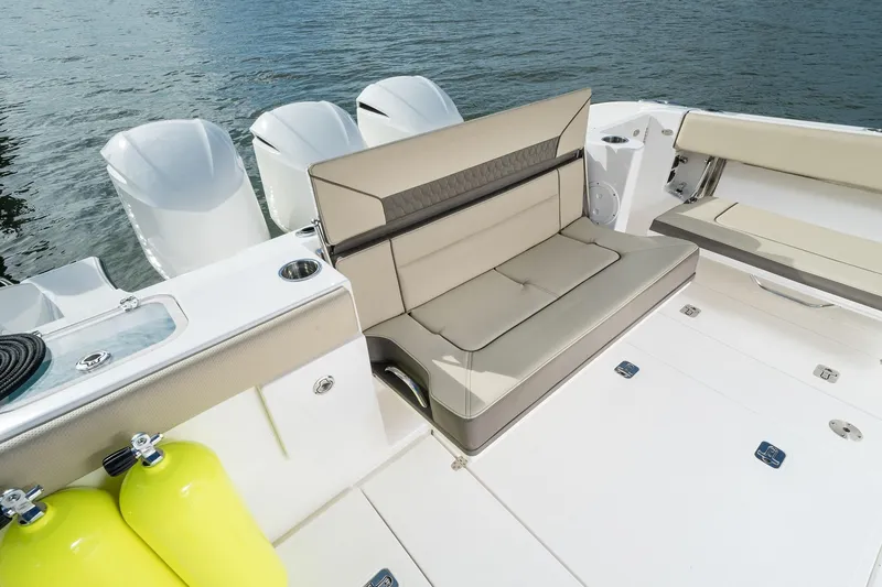 Slide: The Image of 2025 Pursuit DC 365 Dual Console boat with comfortable seating and outboard engines. - 21
