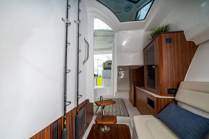 Slide: The Image of Interior of 2025 Pursuit DC 365 Dual Console boat with modern wood finishes. - 23