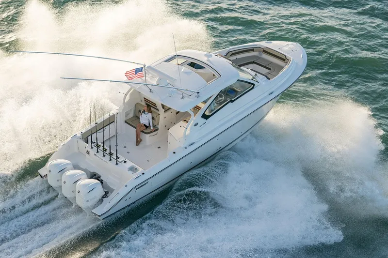 Slide: The Image of 2025 Pursuit DC 365 Dual Console boat cruising on the water. - 4