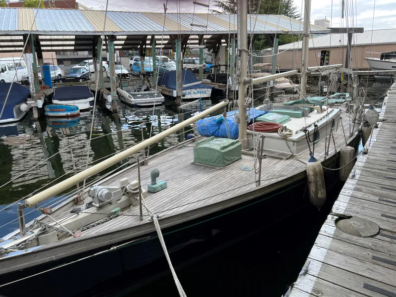 Slide: The Image of 1979 Worldcruiser schooner docked at marina, surrounded by other boats. - 25