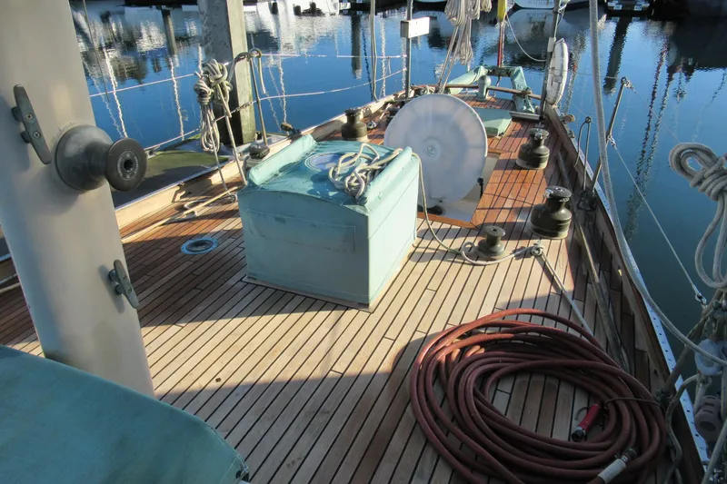 Slide: The Image of 1979 Worldcruiser schooner deck with ropes and winches at a marina. - 3
