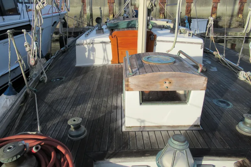 Slide: The Image of 1979 Worldcruiser schooner deck with wooden details and nautical equipment. - 7