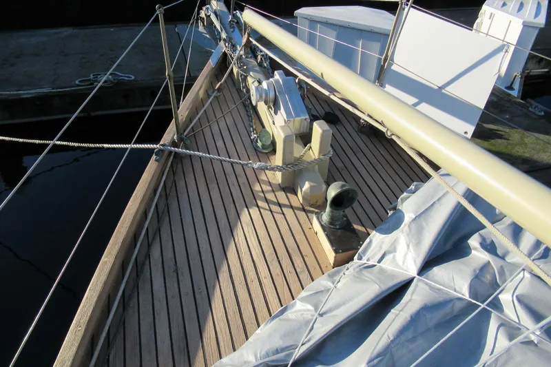 Slide: The Image of Wooden deck of 1979 Worldcruiser schooner with ropes and equipment. - 8