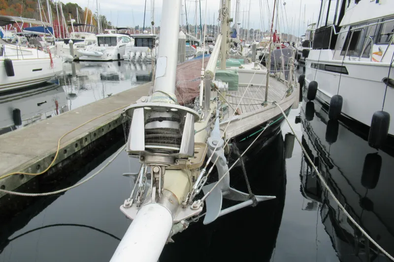 Slide: The Image of 1979 Worldcruiser schooner docked at marina, surrounded by other boats. - 9