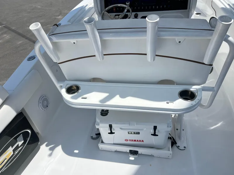 Slide: The Image of 2018 Sea Hunt Gamefish 25 boat interior with rod holders and Yeti cooler. - 14