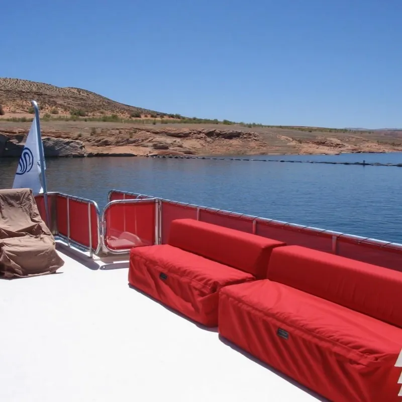 Slide: The Image of Sumerset Red Rocks Trip 5 houseboat, 2008 model, with red seating on a serene lake. - 13