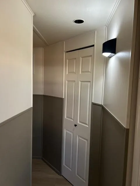 Slide: The Image of Narrow hallway in a 2008 Sumerset Red Rocks Trip 5 houseboat with white and gray walls. - 17