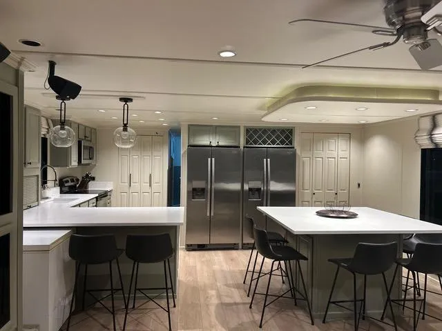 Slide: The Image of Modern kitchen in 2008 Sumerset Red Rocks Trip 5 houseboat with island, bar stools, and stainless steel appliances. - 28