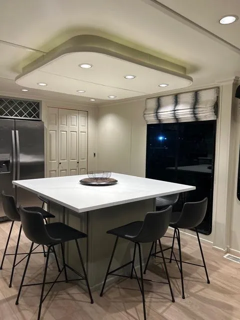 Slide: The Image of Modern kitchen in a 2008 Sumerset Red Rocks Trip 5 houseboat with island and bar stools. - 29