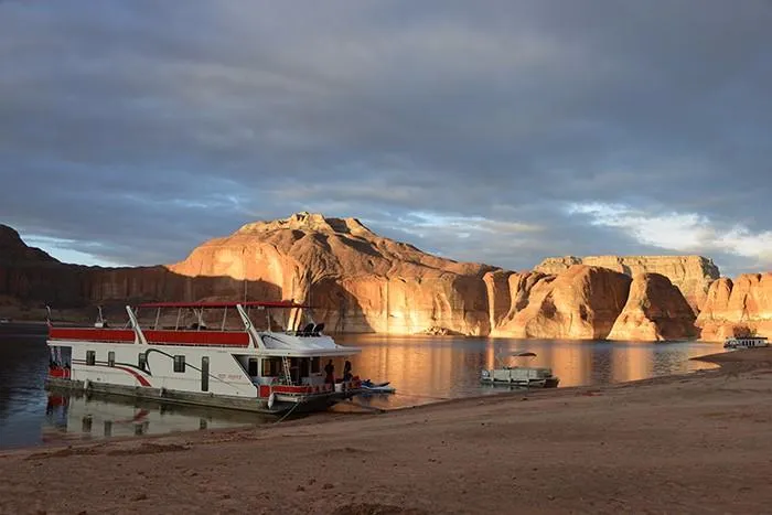 Slide: The Image of Sumerset Red Rocks Trip 5 houseboat on a serene lake with stunning red rock cliffs, 2008. - 4