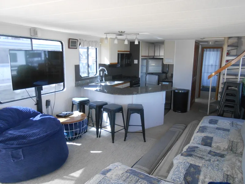 Slide: The Image of Interior of 1990 Skipperliner Custom Houseboat with modern kitchen and cozy living area. - 12