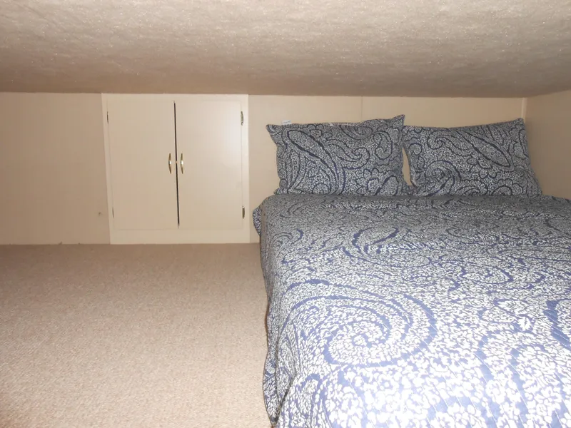 Slide: The Image of Cozy bedroom in 1990 Skipperliner Custom Houseboat with patterned bedding and storage cabinet. - 14