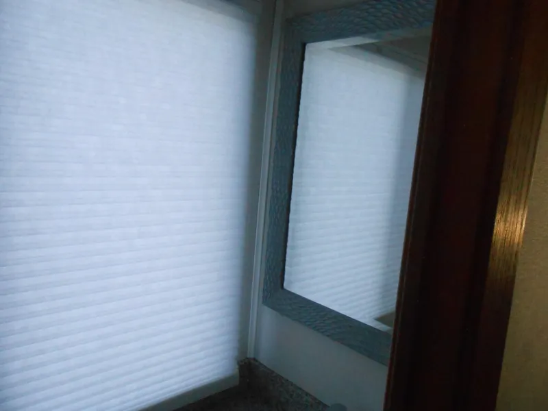 Slide: The Image of Interior of 1990 Skipperliner Custom Houseboat with window and mirror reflection. - 19