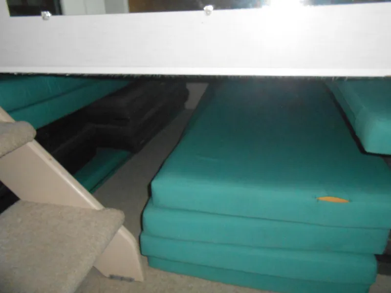 Slide: The Image of Interior of 1990 Skipperliner Custom Houseboat with teal cushions and carpeted stairs. - 23