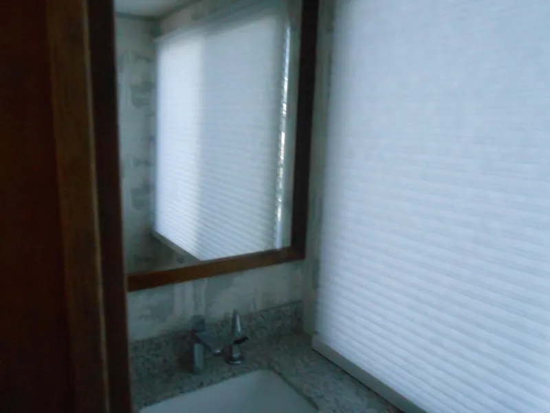 Slide: The Image of Bathroom interior of 1990 Skipperliner Custom Houseboat with sink and window blinds. - 24