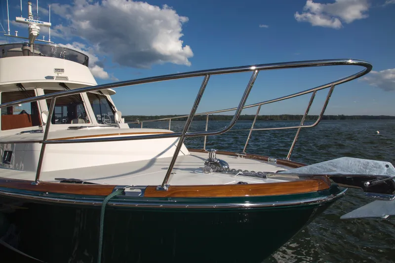 Slide: The Image of 2024 Lyman-Morse HUNT Express Cruiser Flybridge on water, showcasing sleek design and craftsmanship. - 7