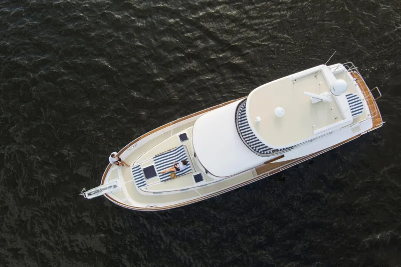 Slide: The Image of Aerial view of 2025 Summit 54 yacht cruising on calm waters. - 14