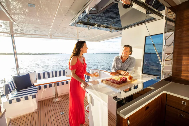 Slide: The Image of Couple enjoying drinks on the deck of a 2025 Summit 54 yacht. - 3