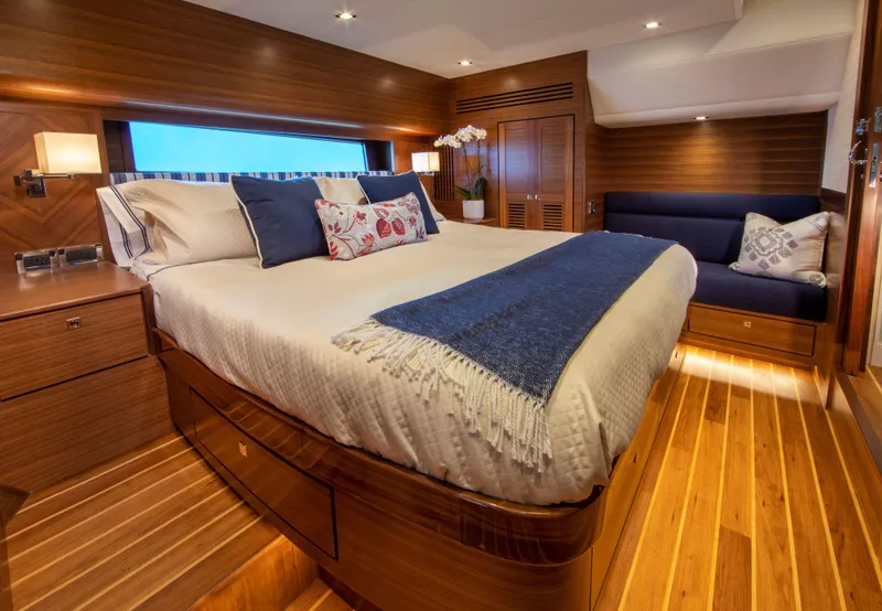 Slide: The Image of Luxurious bedroom interior of Summit 54 yacht, 2025 model, with wooden finishes and cozy bedding. - 6
