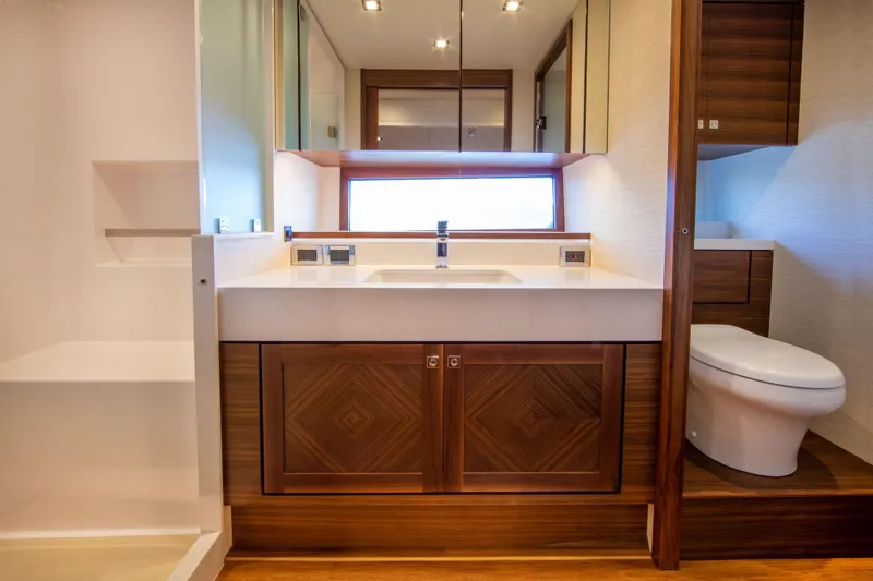 Slide: The Image of Modern bathroom in 2025 Summit 54 yacht with wooden cabinetry and sleek fixtures. - 7