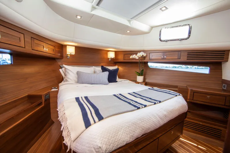 Slide: The Image of Luxurious bedroom interior of 2025 Summit 54 yacht with wooden finishes and cozy bedding. - 8
