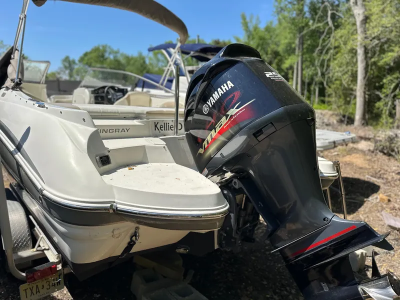 Slide: The Image of 2016 Stingray 234 LR boat with Yamaha outboard motor, parked outdoors. - 39