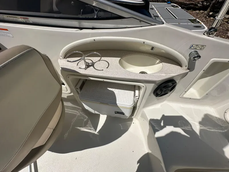 Slide: The Image of Interior of a 2016 Stingray 234 LR boat with sink and storage area. - 49