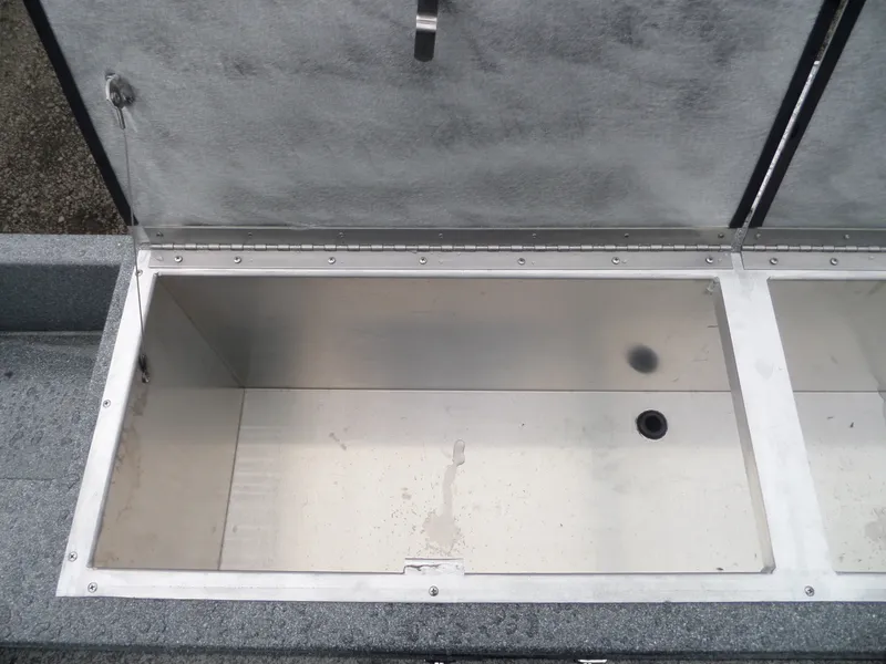 Slide: The Image of Open storage compartment of a 2018 Alumaweld Blackhawk boat. - 12