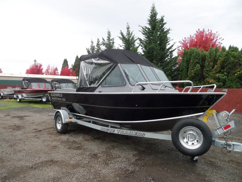 Slide: The Image of 2018 Alumaweld Blackhawk boat on trailer with canopy, parked outdoors. - 8
